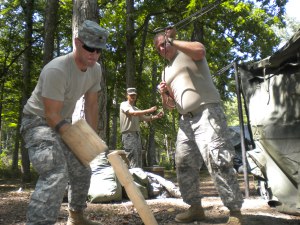 Members of the 438th Military Police set up tents at Land Between the Lakes. Cadet Major Faron Ipox, Murray State University ROTC, hammers in a stake while Spc. Robert Gray stretches a corner of the tent.