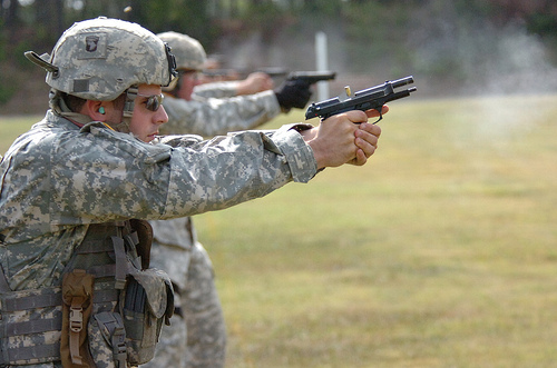 Staff Sgt. Jefferey Ice is firing the pistol.